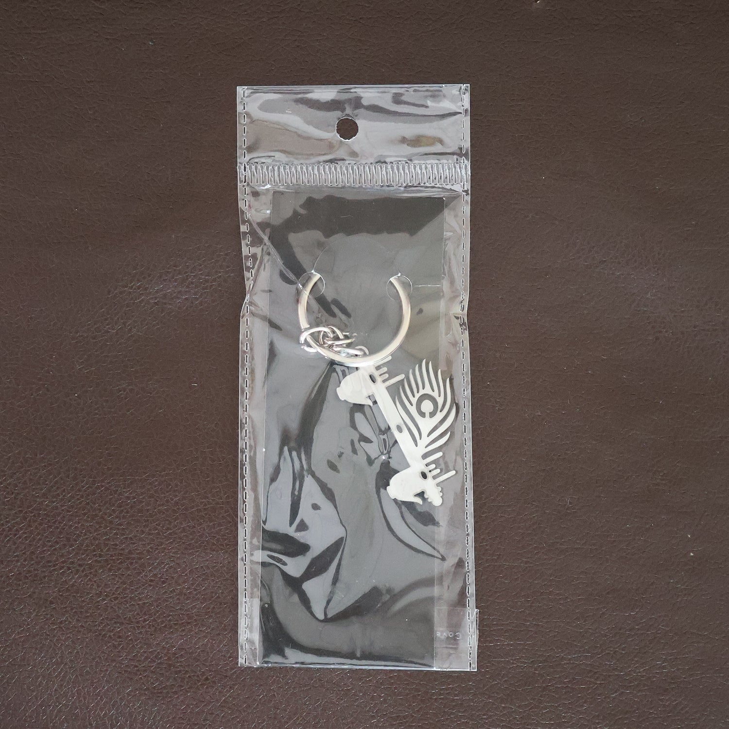 Krishna Flute & Peacock Feather Metal Keychain - (1 Pc) Krishna Flute & Peacock Feather Metal Keychain - (1 Pc)